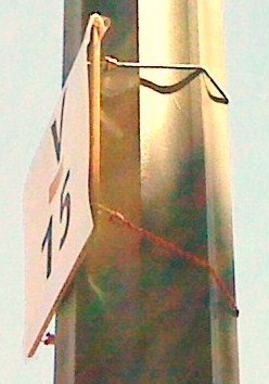 coursemarker on board held to metal pole with bungees